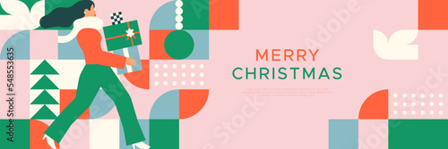 Merry Christmas web banner template illustration of woman carrying gift with colorful abstract geometric mosaic art. Holiday business sale event or xmas greeting card design. 