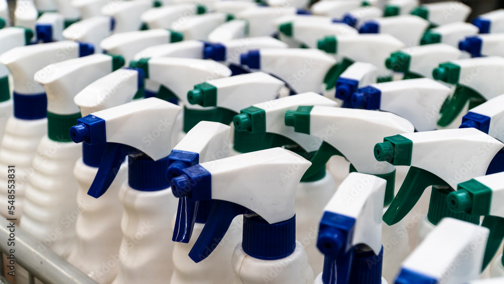 Obraz premium sprayer bottle. Group of white sprayer bottles high angle view. Cleaning equipments concept. Selective focus included