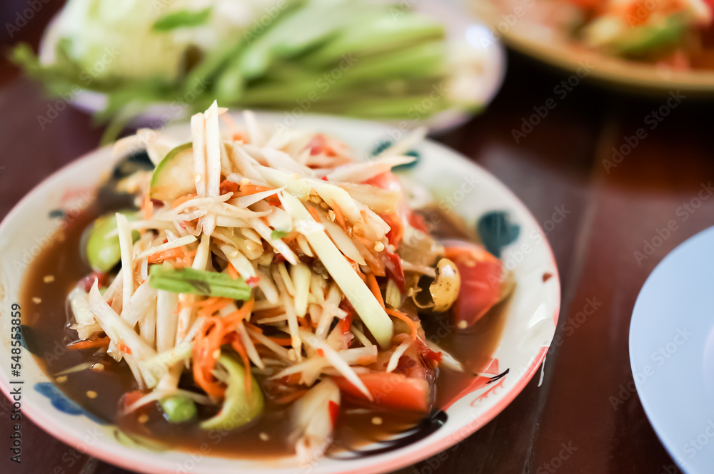 Thai green papaya salad, which is also known as Som Tam is one of the most commonly available and most popularly consumed dishes in all of Thailand. Thai green papaya salad, which is also known as Som Tam is one of the most commonly available and most popularly consumed dishes in all of Thailand.