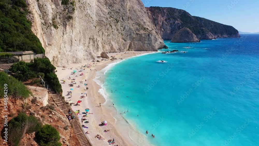 Aerial drone video of popular paradise deep turquoise beach of Porto Katsiki with white steep rocky seascape and beautiful cloudy landscape, Lefkada island, Ionian, Greece Aerial drone video of popular paradise deep turquoise beach of Porto Katsiki with white steep rocky seascape and beautiful cloudy landscape, Lefkada island, Ionian, Greece