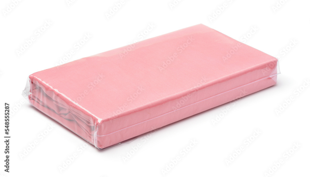 Folded pink cotton bedding sheets in clear plastic bag Folded pink cotton bedding sheets in clear plastic bag