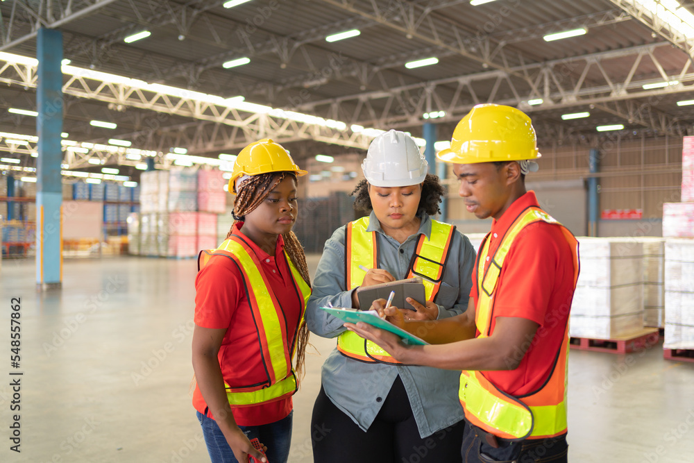 Teamwork of black workers and fat woman working in large warehouse retail store industry. Rack of stock storage. Interior of cargo in ecommerce and logistic. Depot. People lifestyle. Shipment service. Teamwork of black workers and fat woman working in large warehouse retail store industry. Rack of stock storage. Interior of cargo in ecommerce and logistic. Depot. People lifestyle. Shipment service.