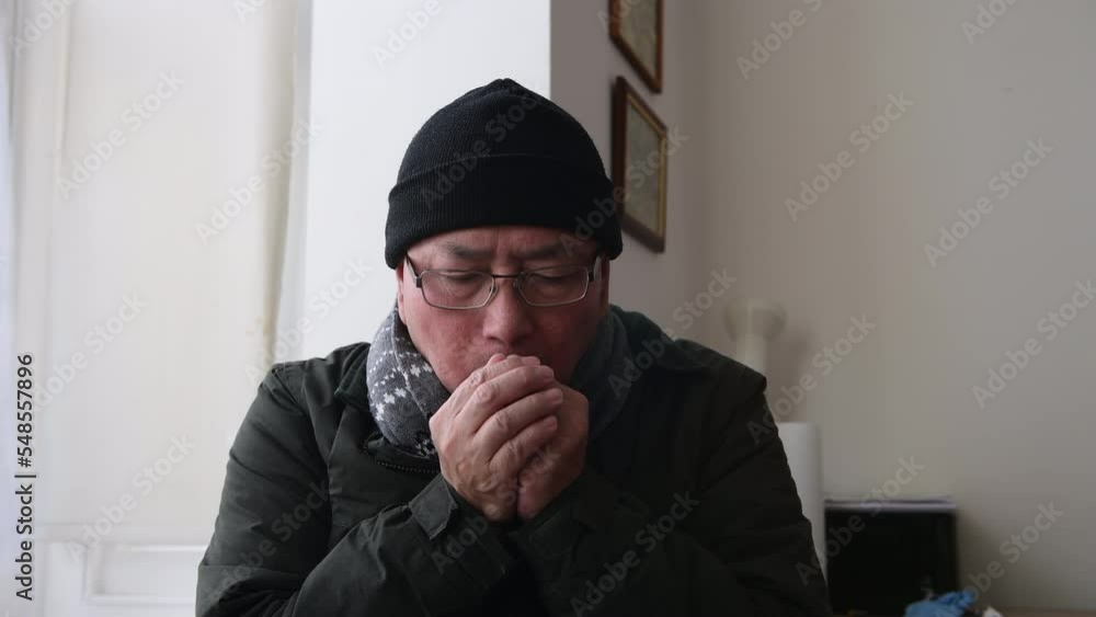 A senior man trying to keep warm indoors as household energy cost more than doubled. A senior man trying to keep warm indoors as household energy cost more than doubled.