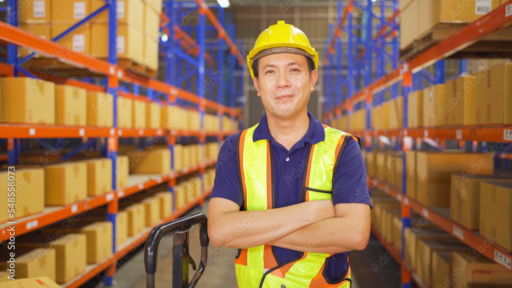 Portrait of Asian worker working in large warehouse retail store industry. Rack of stock storage. Interior of cargo in ecommerce and logistic concept. Depot. People lifestyle. Shipment service. Portrait of Asian worker working in large warehouse retail store industry. Rack of stock storage. Interior of cargo in ecommerce and logistic concept. Depot. People lifestyle. Shipment service.