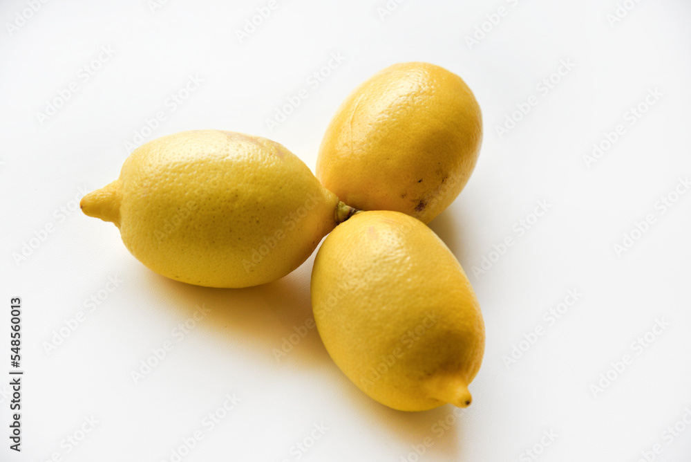 Yellow ripe lemon on a white background. Juicy lemons close-up. Isolate of the fruit of a yellow lemon. Yellow ripe lemon on a white background. Juicy lemons close-up. Isolate of the fruit of a yellow lemon.