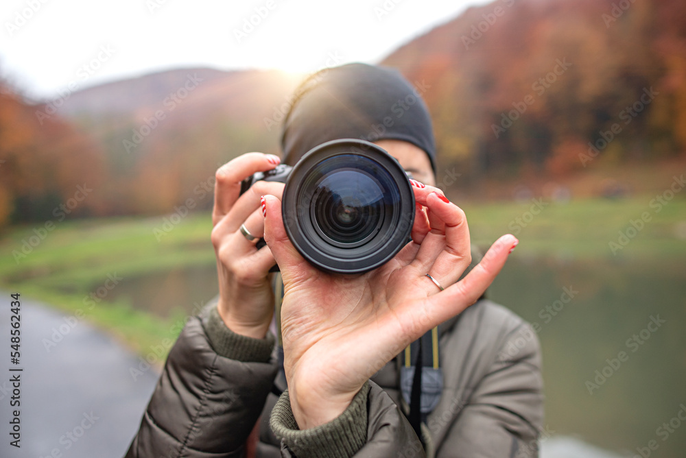 Girl with a dslr camera outdoors in the cold season.