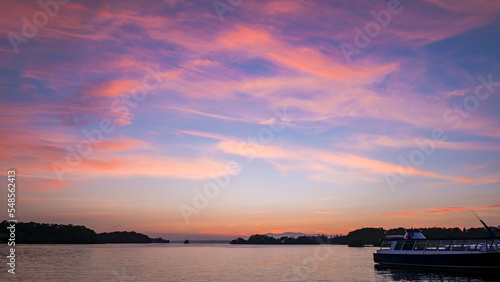 Sunset over a lake in Ireland with a boat moored to the side