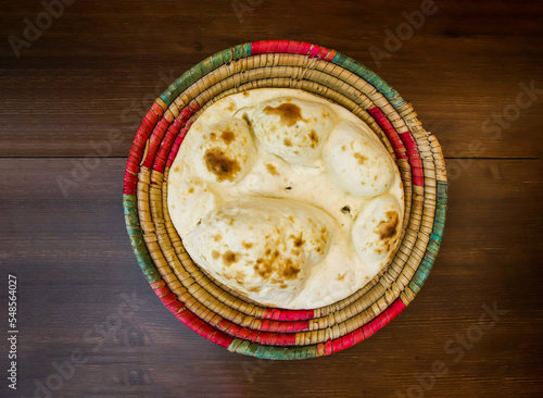 Photography Tandoori khamiri roti served in basket isolated on table top view of india and p