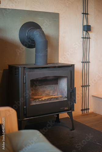 modern fireplace in plywood interior of a timber house