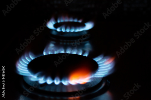 Blue flames of gas burners on a black background