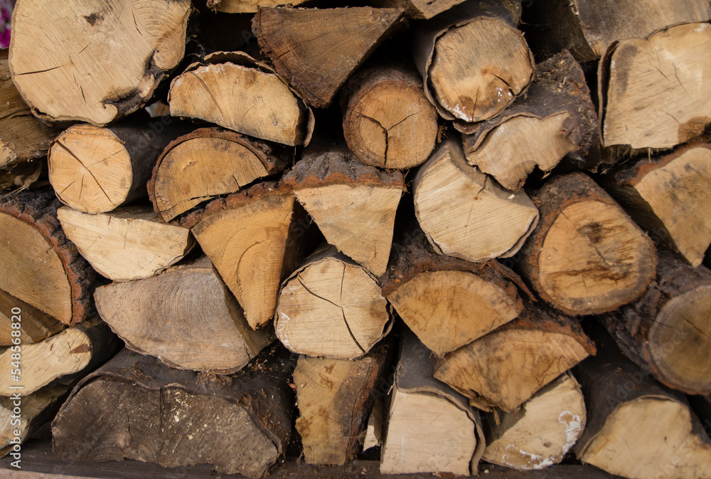 Chopped stacks of firewood for industrial. Piles of firewood closeup. Preparation of firewood for the winter during high prices of energy resources. Chopped stacks of firewood for industrial. Piles of firewood closeup. Preparation of firewood for the winter during high prices of energy resources.