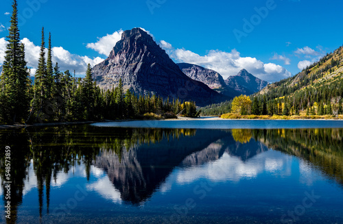 Sinopah Mountain across Two Medicine Lake with fall foliage photo