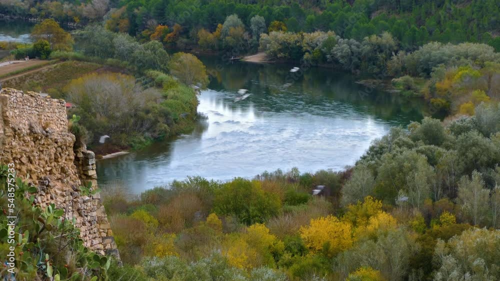 Mediterranean Rivers View of the Ebro river with some doves flying by, in the province of ...