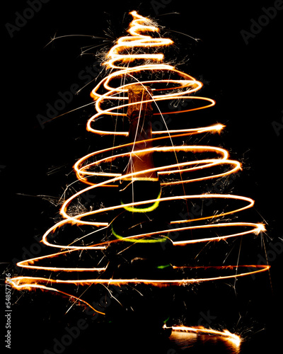 Golden bottle of champagne with sparklers on a dark background