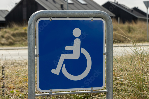 Blue colored sign for disabled car parking. 