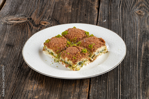 Traditional Turkish dessert cold baklava in the plate. Geleneksel Soguk baklava. photo