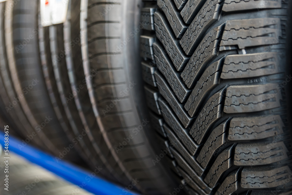 Tire installation concept. Winter and summer car tires. Seasonal winter tyre change. Snow tire lying on ground, is ready to install, spring Tire installation concept. Winter and summer car tires. Seasonal winter tyre change. Snow tire lying on ground, is ready to install, spring