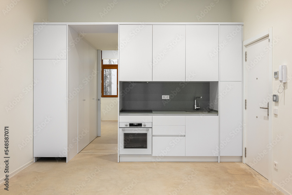 White empty classic kitchen in front view in new or refurbished apartment White empty classic kitchen in front view in new or refurbished apartment