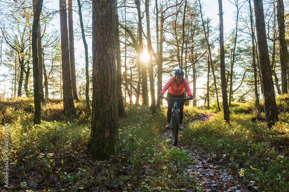 Woman riding a bike in the woods Woman riding a bike in the woods