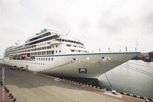 a large sea passenger liner is moored in the port.
