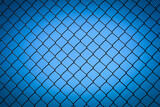 Mesh fence close-up with blue sky background