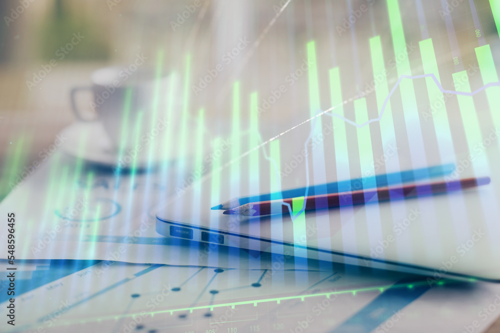 Forex graph hologram on table with computer background. Double exposure. Concept of financial markets. Forex graph hologram on table with computer background. Double exposure. Concept of financial markets.