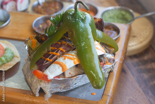 Carne asada plate with mexican food and sauces