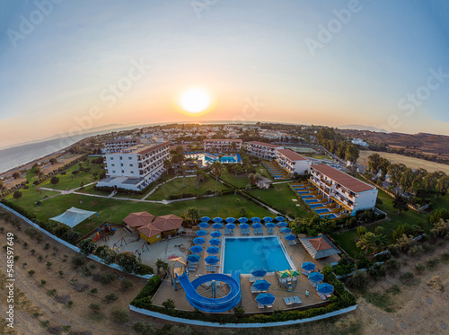 Sunrise behind the hotel with swimming pool photo