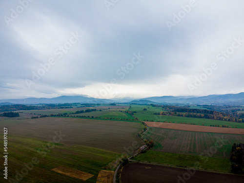 Aerial view of meadows, fields and mountains