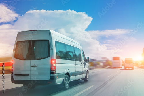Canvas Print Passenger white bus van accelerating ride motion blur effect.