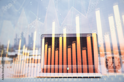 Forex graph hologram on table with computer background. Multi exposure. Concept of financial markets.