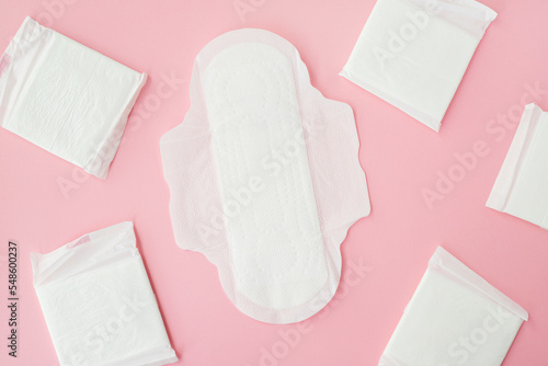 Many sanitary napkin on pink background photo