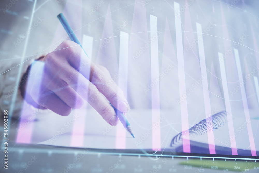 Financial forex graph displayed on hands taking notes background. Concept of research. Double exposure Financial forex graph displayed on hands taking notes background. Concept of research. Double exposure