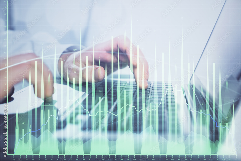 Double exposure of market chart with man working on computer on background. Concept of financial analysis.