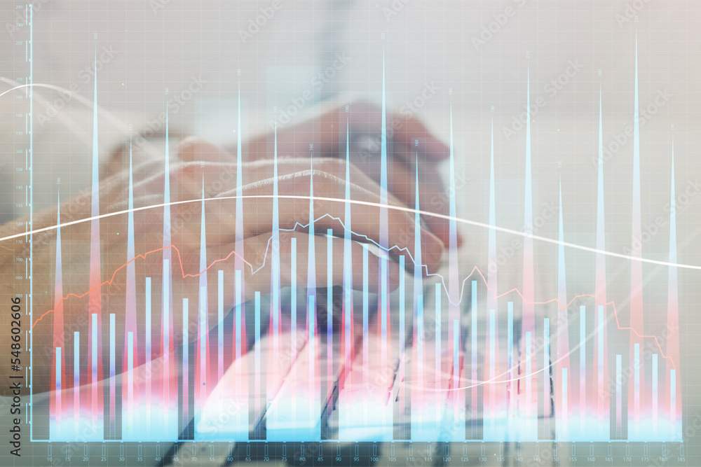 Double exposure of graph with man typing on computer in office on background. Concept of hard work. Closeup. Double exposure of graph with man typing on computer in office on background. Concept of hard work. Closeup.
