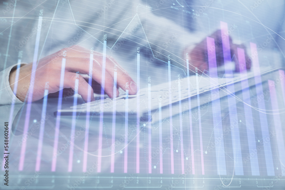 Double exposure of graph with man typing on computer in office on background. Concept of hard work. Closeup. Double exposure of graph with man typing on computer in office on background. Concept of hard work. Closeup.
