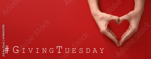 Banner with female hands making heart shape on red background. Giving Tuesday photo