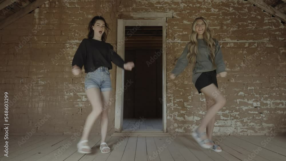 Teenage girls performing dance routine in empty attic / Grafton, Utah, United States Teenage girls performing dance routine in empty attic / Grafton, Utah, United States