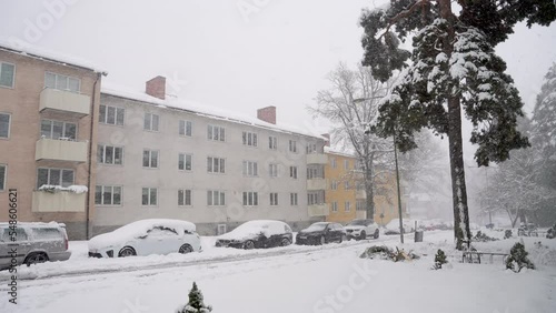 Heavy snowfall blizzard in residential apartment area photo