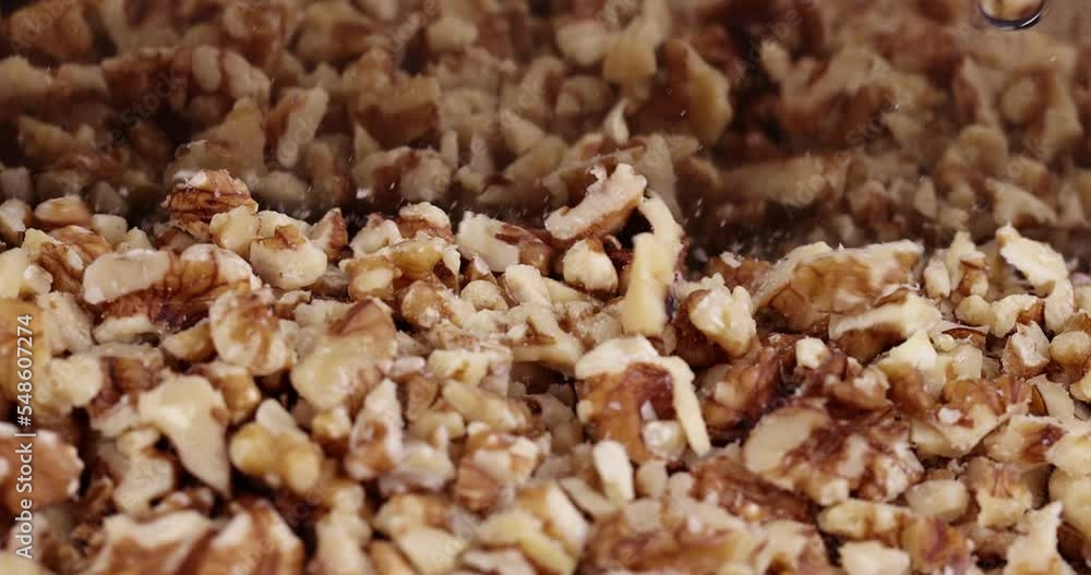 Cut and chop walnuts on a board, cut ripe walnuts into pieces for use in cooking Cut and chop walnuts on a board, cut ripe walnuts into pieces for use in cooking