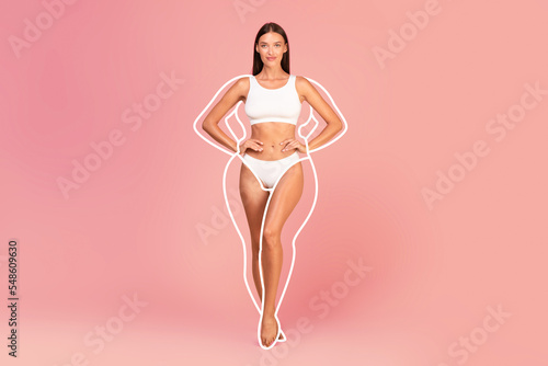 Slim smiling woman in white lingerie with drawn silhouette around body