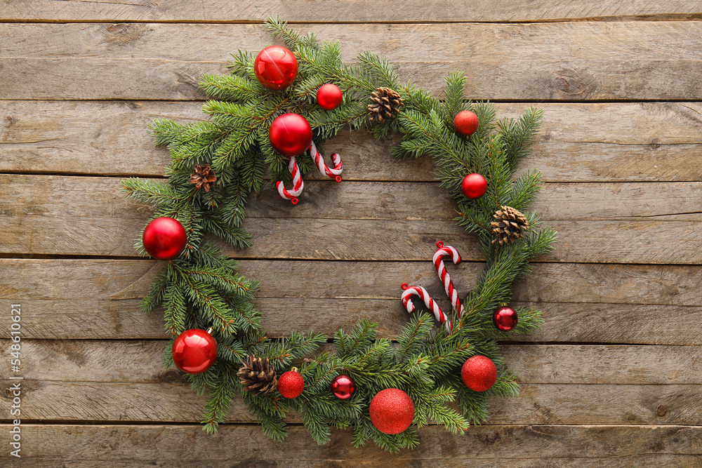 Christmas wreath made of fir branches and decorations on wooden background Christmas wreath made of fir branches and decorations on wooden background