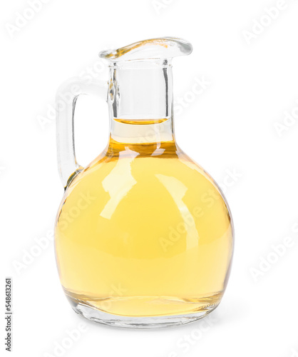 Glass decanter of apple cider vinegar on white background