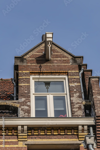 Old building (XVII- XVIII centuries) with gable rooftop and hook Amsterdam’s Kattenburg. Kattenburg is Island in Amsterdam that were built in second half of XVII century. Amsterdam, the Netherlands.