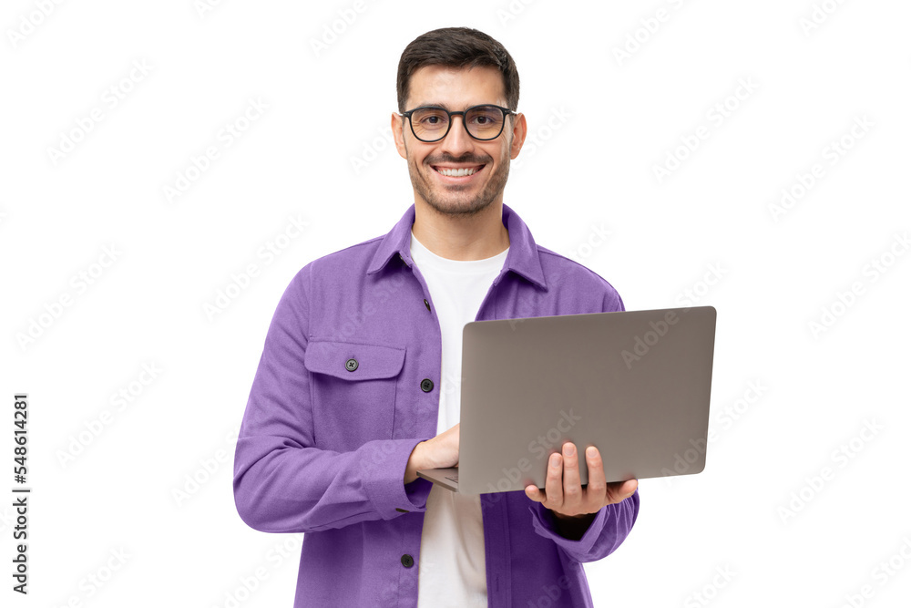 Studio portrait of young man standing holding laptop and looking at camera with happy smile Studio portrait of young man standing holding laptop and looking at camera with happy smile