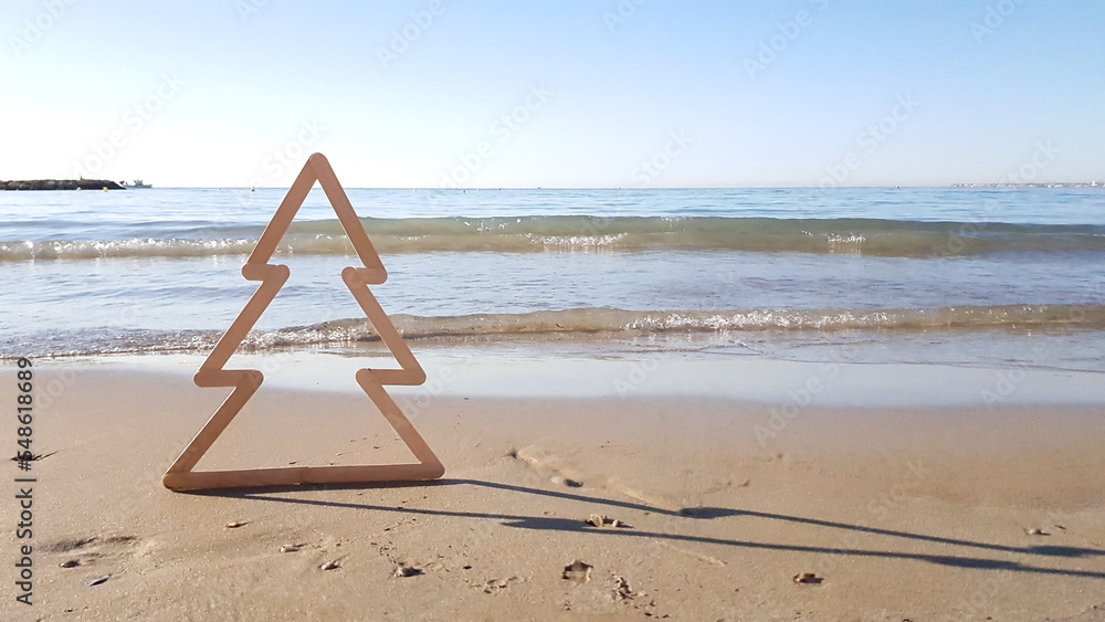 siluet Christmas tree on the beach on the background of the sea in Spain siluet Christmas tree on the beach on the background of the sea in Spain
