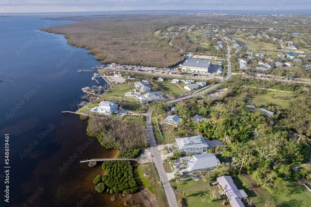 Fototapeta premium Hurricane Ian destroyed homes in Florida residential area on golf course. Natural disaster and its consequences