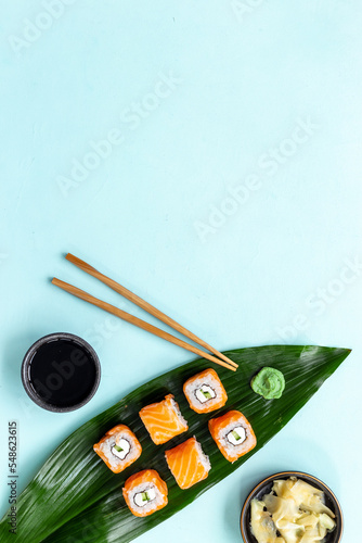 Sushi roll set with chopsticks on green Bamboo leave, top view