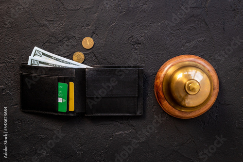 Hotel service bell with wallet and cash. Hotel payment concept