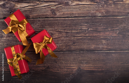 Three Christmas gift boxes on wooden background